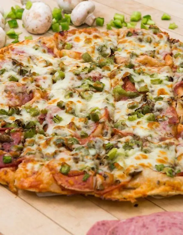 Fresh thin-crust pizza for community fundraisers in Steinbach, MB.]